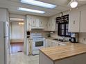 Well-lit kitchen featuring ample cabinet space, updated appliances, and an adjacent dining area at 1007 Forest Lake Dr, Lakeland, FL 33809