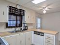 Functional kitchen space with stainless steel sink, wood countertops, and vintage dishwasher at 1007 Forest Lake Dr, Lakeland, FL 33809