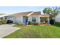 Delightful single-story home featuring a manicured lawn, an attached garage, and a screened in porch at 1021 Meadowood Pointe Rd, Lakeland, FL 33811