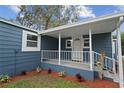 Cozy front porch featuring white railings and a freshly painted exterior at 1115 S Virginia Ave, Bartow, FL 33830