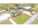 Aerial view of a single-story home featuring a large in-ground pool, solar panels, and lush landscaping at 1160 Ilene Ave, Bartow, FL 33830