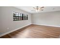 Bright bedroom with hardwood floors, neutral walls, and a large window for natural light at 1180 E Hill Ct, Bartow, FL 33830