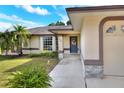 Inviting home exterior showcases a well-manicured lawn, covered entryway, and a charming bay window feature at 2597 Highlands Vue Pkwy, Lakeland, FL 33812