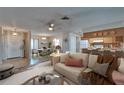 Open concept living room seamlessly blends a dining area and kitchen, creating a welcoming and connected living space at 3823 Woodburn E Loop, Lakeland, FL 33813