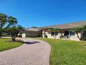 Circular brick driveway providing ample parking and enhancing the curb appeal at 4025 Cheverly E Dr, Lakeland, FL 33813