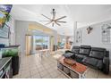 Bright living area showcases a sliding glass door to the deck, tile floors, and a comfortable seating arrangement at 404 Emerald Cove Loop, Lakeland, FL 33813