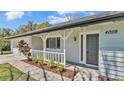 Close up of the front of the home highlighting the front porch, home address, and detailed exterior at 4059 The Fenway, Mulberry, FL 33860