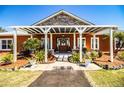 Inviting front porch with white pergola, decorated door, and lush plants at 408 Old Bartow Lake Wales Rd, Bartow, FL 33830