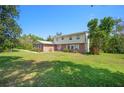 Charming two-story home with a brick facade, white shutters and a well-maintained front yard and lush landscaping at 4908 S Bedford Ln, Lakeland, FL 33813