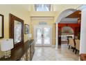 Bright foyer with soaring ceilings and elegant double-door entrance at 502 Lake Harris Dr, Lakeland, FL 33813