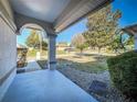 View from covered front porch of the well-maintained lawn and landscaping including trees and bushes at 5730 Tanasi Ct, Lakeland, FL 33812