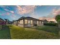 Exterior view of backyard showing covered sunroom and lawn at 6211 Crane Dr, Lakeland, FL 33809