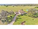 Aerial view featuring a beautiful home surrounded by lush green land at 6383 Summertimes Plantation Blvd, Bartow, FL 33830