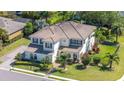 Expansive aerial view showcasing the home's tile roof, lush landscaping, and the surrounding neighborhood at 6515 Eagle View Loop, Lakeland, FL 33813