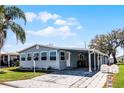 Inviting home with a carport, well-maintained lawn, and mature trees for shade and curb appeal at 6634 Princeton Ne Dr, Winter Haven, FL 33881