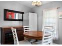 Cozy eat-in kitchen with wood table and chairs plus a hutch and a view of the red front door at 6634 Princeton Ne Dr, Winter Haven, FL 33881