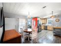 Eat-in kitchen features wood cabinets, stainless appliances, and a red accent door at 6634 Princeton Ne Dr, Winter Haven, FL 33881