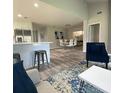 Open-concept living area showcasing wood floors, a modern kitchen, and comfortable seating at 692 Augusta Rd, Winter Haven, FL 33884