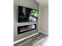 Living room featuring an electric fireplace below the mounted tv at 692 Augusta Rd, Winter Haven, FL 33884