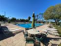 Inviting community pool area with umbrella tables and comfortable lounge seating at 692 Augusta Rd, Winter Haven, FL 33884
