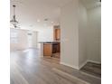 Bright living room and kitchen area with durable wood flooring and modern fixtures at 726 Chacall Loop, Mount Dora, FL 32757