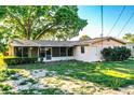 Single-story home showing back screened in porch at 1225 Pleasant Pl, Lakeland, FL 33801