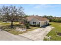 Well-maintained single-story home with a concrete driveway and landscaped front yard at 124 Brandy Chase Blvd, Winter Haven, FL 33880