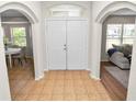 Inviting home foyer featuring tile floors, arched entryways, and a view of the living spaces at 124 Brandy Chase Blvd, Winter Haven, FL 33880