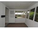 Bright sun room with white wood paneling and multiple windows with screens for natural light at 129 Nw 10Th Dr, Mulberry, FL 33860