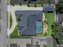 Top-down aerial view of a single-Gathering home showcasing the screened-in pool, gray roof, and lush backyard at 152 Melissa Trl, Auburndale, FL 33823
