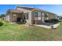 Back exterior with siding, well-kept lawn, back patio and landscaping at 1939 Prairie Dunes N Cir, Lakeland, FL 33810