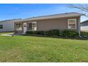 Back exterior with siding, well-kept lawn and landscaping at 1939 Prairie Dunes N Cir, Lakeland, FL 33810