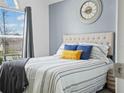 Bright main bedroom with a large window, wood-look floors, and stylish decor at 300 Keswick Ave, Davenport, FL 33897