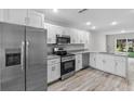 Modern kitchen features stainless steel appliances, granite countertops, and ample cabinet space at 304 Ave P Nw, Winter Haven, FL 33881