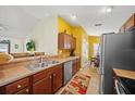 Open kitchen layout with stainless steel appliances and a breakfast bar overlooking the dining area at 3137 Winchester Estates Loop, Lakeland, FL 33810