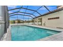 A screened-in pool with clean water is perfect for relaxing with views of the backyard at 3919 Vista Trace Way, Lakeland, FL 33810