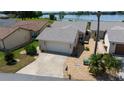 Aerial view of a single-story home, attached two-car garage and simple front yard landscaping at 3960 W Cypress Lndg, Winter Haven, FL 33884