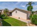 A single-story home with a well-kept lawn, simple landscaping and an attached two-car garage at 3960 W Cypress Lndg, Winter Haven, FL 33884