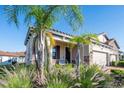 Well-maintained home exterior featuring a brick driveway, lush landscaping, and a charming facade at 4189 Marseille Ln, Lakeland, FL 33810