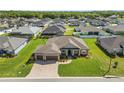 Beautiful aerial view of the residence showcasing the roof, driveway, and lush landscaping at 5020 Truman Ln, Lakeland, FL 33812