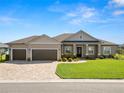 Charming single-story home featuring a well-manicured lawn and a spacious two car garage at 5020 Truman Ln, Lakeland, FL 33812