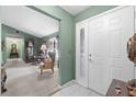 Inviting foyer features tile flooring, a decorative front door, and views of the living area at 5432 Weber Pl, Lakeland, FL 33809