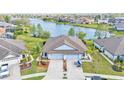 A captivating aerial view of the home, situated on a waterfront property with lush landscaping at 5883 Great Salt Ct, Lakeland, FL 33805