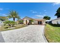 Beautiful residence with a manicured lawn and a gorgeous brick driveway, presenting an inviting curb appeal at 6059 Condor Dr, Lakeland, FL 33809