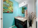 Cozy half bath with a granite countertop, decorative vase and modern vanity lighting at 661 Black Eagle Dr, Groveland, FL 34736