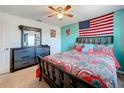 Bedroom featuring a colorful paisley bedspread, ceiling fan, and a large dresser with mirror at 661 Black Eagle Dr, Groveland, FL 34736
