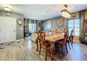 Open-concept dining area with stylish table, chairs, and chandelier, perfect for entertaining guests at 661 Black Eagle Dr, Groveland, FL 34736