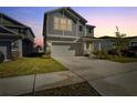 Charming two-story home featuring neutral gray siding, manicured lawn and an attached two-car garage at 728 Trotters Dr, Eagle Lake, FL 33839