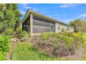 An enclosed screened porch featuring landscaping and a peaceful outdoor living space at 914 Christina Chase Dr # Drive, Lakeland, FL 33813