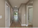 Spacious hallway with wood-look flooring leading to living areas and bedrooms at 1013 Rhodes S Rd, Haines City, FL 33844
